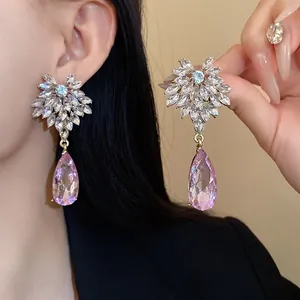 Elegant detailed macro shot of floral crystal drop earrings with pink teardrop stones
