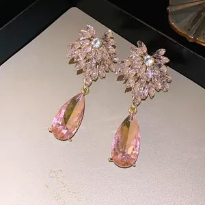 Exquisite macro detail of pink crystal floral drop earrings with elegant gold finish