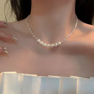 Close-up of a French retro irregular silver chain necklace with seven pearls