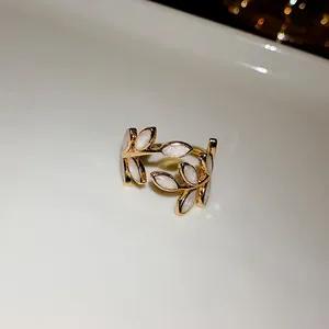 Elegant gold-plated leaf open ring featuring white glitter inlay for a niche design look