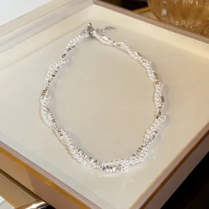 Detail view of twisted silver bead and pearl necklace on display tray