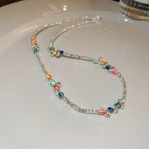 Detailed view of a silver-toned beaded necklace featuring vibrant irregular accents.