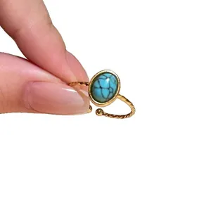 Elegant gold plated adjustable open ring featuring a vintage oval turquoise stone