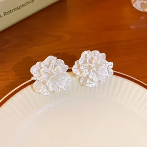 Detailed view of elegant white flower stud earrings with a unique textured petal design