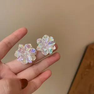 Detail view of iridescent floral petal stud earrings featuring a romantic aesthetic