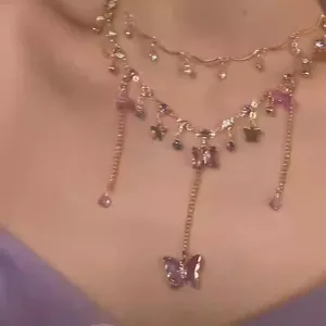 Close-up of double-layered necklace featuring purple resin butterflies and tassels