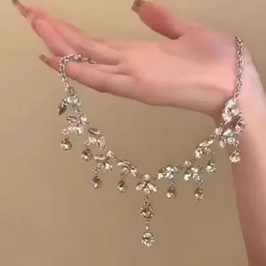 Detailed view of an elegant silver-tone zircon necklace with cascading teardrop pendants