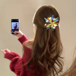 Close-up of a colorful flocking LED firework hair clip worn on long wavy hair.