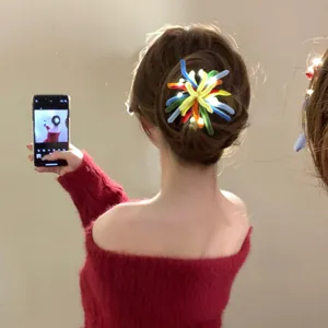 Detailed view of a glowing colorful firework hair clip worn on a bun hair style