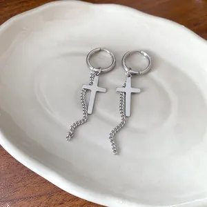 Silver stainless steel hoop earrings featuring cross charm and dangling chain detail