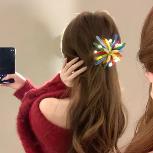 Close-up of a colorful flocked firework hair clip with LED lights on long hair.