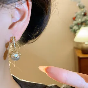 Detailed view of French retro gold-plated earrings featuring lace pearl and zirconia details