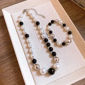 Elegant contrast pearl necklace and bracelet set with black, white, and silver beads