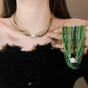 Close-up view of multi-layer crystal bead necklace with sparkling pavé ball clasp