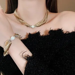 Elegant multi-layer crystal wrap necklace and bracelet set shown on model in detail shot
