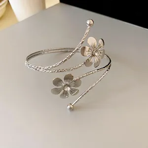 Macro view of a silver floral cuff bracelet with rhinestone centers