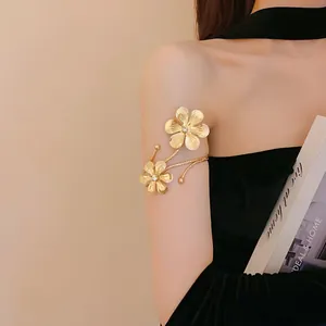 Elegant golden flower open armlet with sparkling crystal accent worn by model