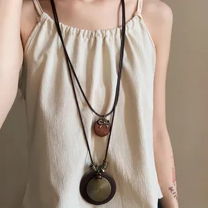 Lange zweilagige Ethno-Halskette mit Holzanhängern und Retro-Bronzespiral-Design