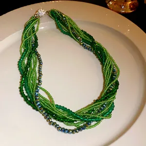 Close-up of bohemian multi-strand green crystal bead necklace with rhinestone clasp