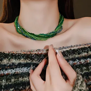 Detailed close-up view of a Bohemian multi-layer green beaded choker necklace on a model