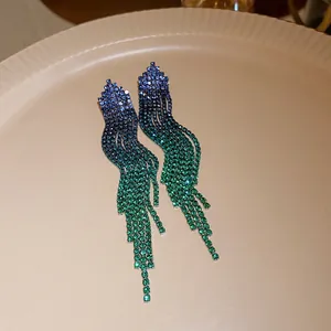 Detailed close-up of long tassel earrings with blue to green gradient zircon stones