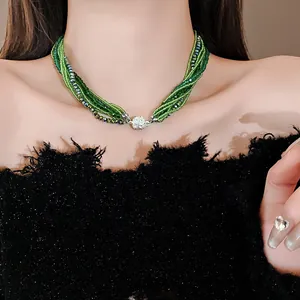 Elegant bohemian multi-layer green beaded choker necklace worn by a female model.