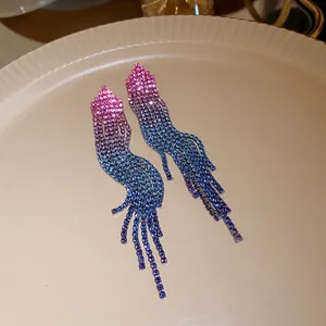 Close-up view of elegant gradient blue and pink color zircon long tassel drop earrings.