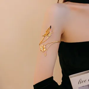 Detailed view of elegant gold upper arm bracelet with butterfly and flower design