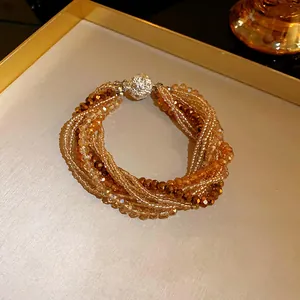 Close-up detail of bohemian multi-strand crystal bracelet with elegant rhinestone clasp