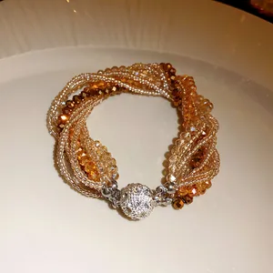 Detailed close-up of a bohemian multi-layer crystal beaded bracelet with rhinestone clasp.