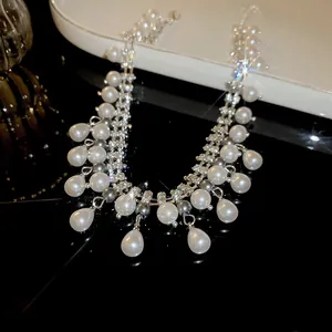 Elegant multi-strand necklace featuring white pearls and sparkling zircon crystal accents