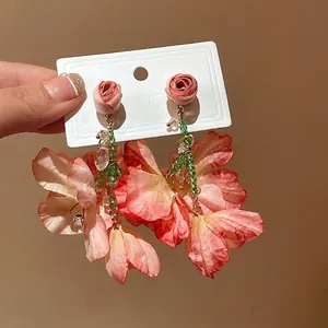 Handmade sweet floral tassel earrings featuring pink fabric petals and elegant green beads