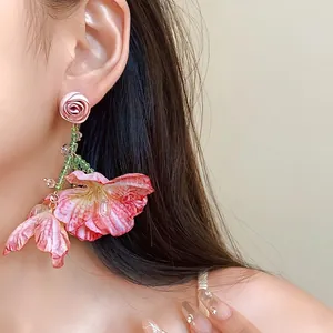 Elegant pink mesh flower tassel earrings with green beads and silver needles.