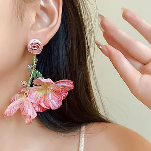 Detailed macro shot of sweet pink mesh flower earrings with crystal fringe accents