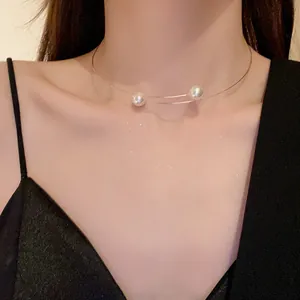 Detailed close-up view of elegant minimalist double-layered wire choker featuring two pearls.