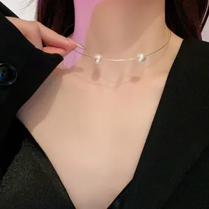Detail view of a minimalist thin wire choker necklace with two elegant pearls