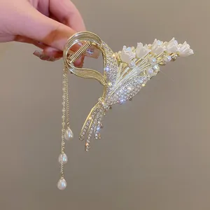 Detailed view of lily of the valley hair claw clip with pearls and sparkling rhinestones