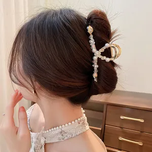 Elegant pearl lily of the valley hair claw clip with rhinestones for stylish updo hairstyles.