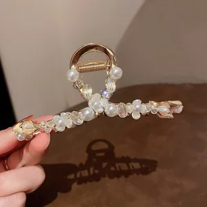 Close-up of elegant pearl and rhinestone floral hair claw clip for women's styling