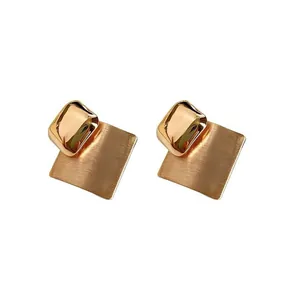Gold-plated brushed metal rhombus stud earrings with minimalist geometric design.