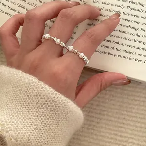 Minimalist irregular pearl elastic ring on hand featuring a trendy Korean design.