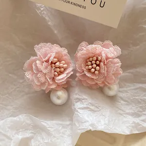 Detailed view of elegant pink lace flower earrings featuring large white pearl drops