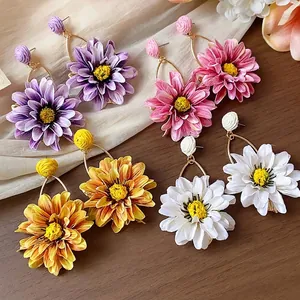 Elegant handmade raffia flower hoop earrings set in vibrant purple pink yellow and white