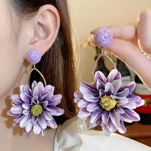 Handmade bohemian purple fabric flower drop earrings with woven raffia stud detail