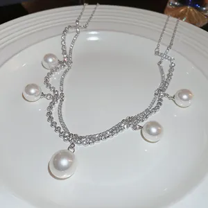 Elegant French style double-layer pearl necklace with sparkling crystals on white plate
