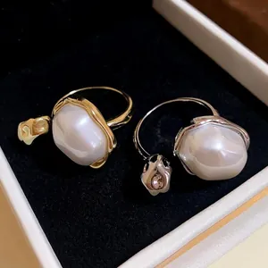 Elegant gold and silver plated open rings with large baroque pearls in a black velvet box.