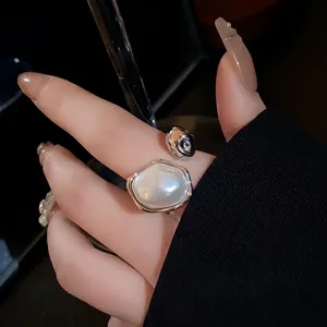 Elegant vintage gold-plated pearl oval open ring worn on a finger as a main view