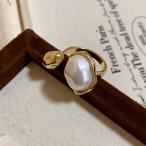 Close-up of a vintage gold plated open ring with a large oval baroque pearl detail
