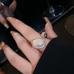 Detailed view of an oval pearl open ring with elegant silver-plated metallic finish