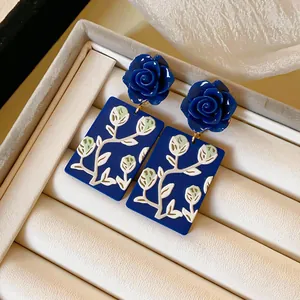 Detailansicht dunkelblauer Rosen-Ohrhänger mit Blumendruck auf Acryl-Rechtecken.